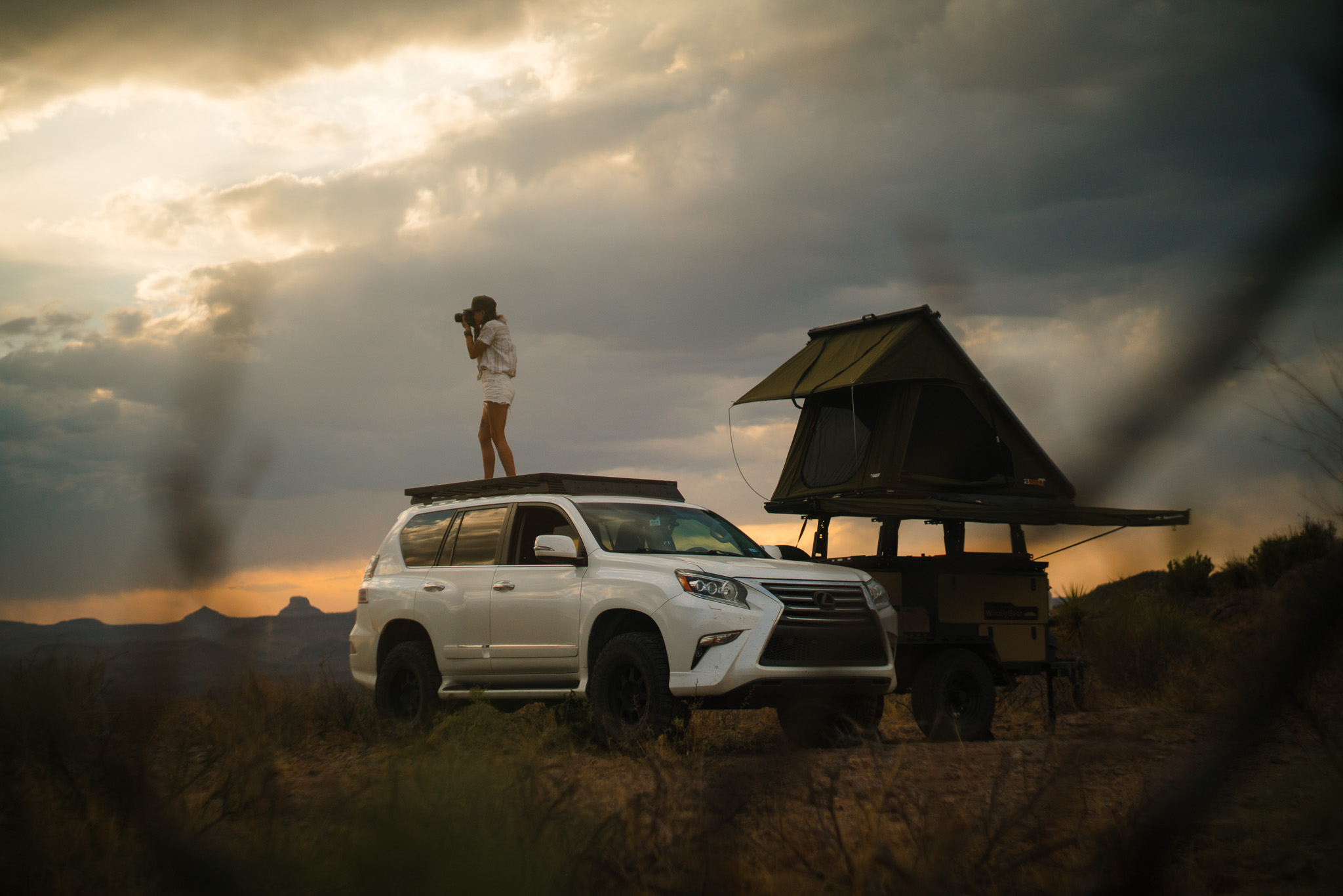 Ally on an adventure, photographing wildlife from the roof of her SUV.